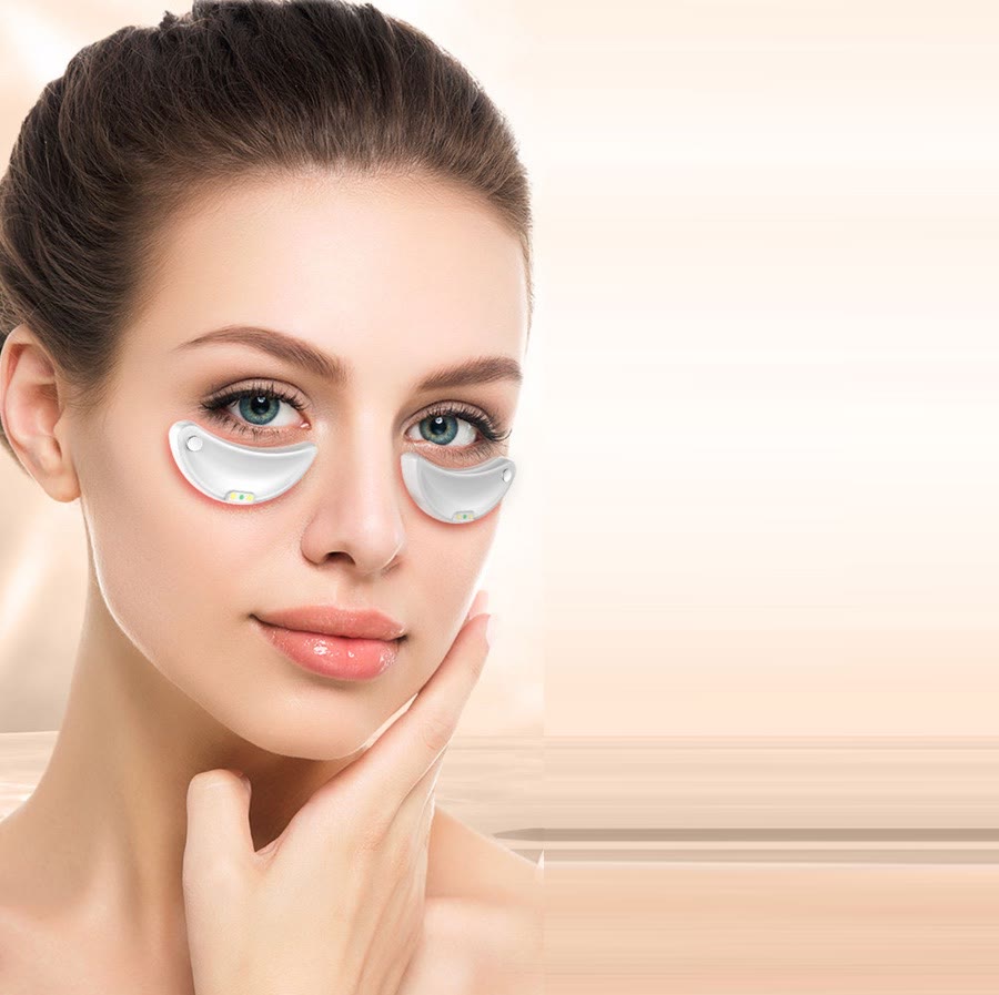 A woman wearing The Rest: a white, contoured device resting under each eye